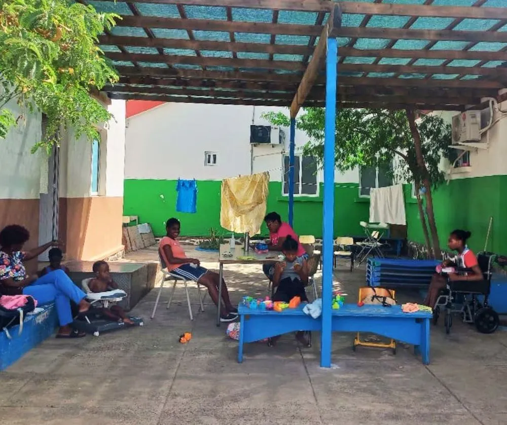 Volunteer group visiting the colourful Tarrafal sign on Santiago Island, showing the Cape Verde setting of Abroad Escape volunteer programs.