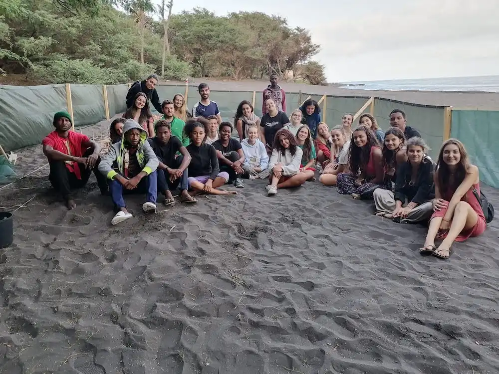 Volunteer group visiting the colourful Tarrafal sign on Santiago Island, showing the Cape Verde setting of Abroad Escape volunteer programs.