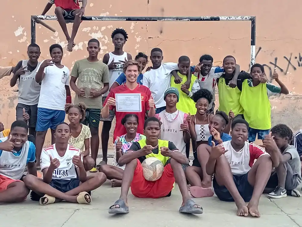 Volunteer group visiting the colourful Tarrafal sign on Santiago Island, showing the Cape Verde setting of Abroad Escape volunteer programs.