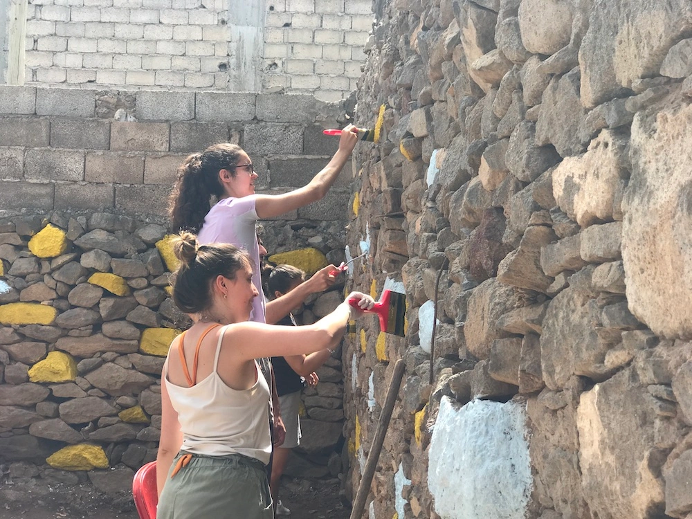 Volunteer group visiting the colourful Tarrafal sign on Santiago Island, showing the Cape Verde setting of Abroad Escape volunteer programs.