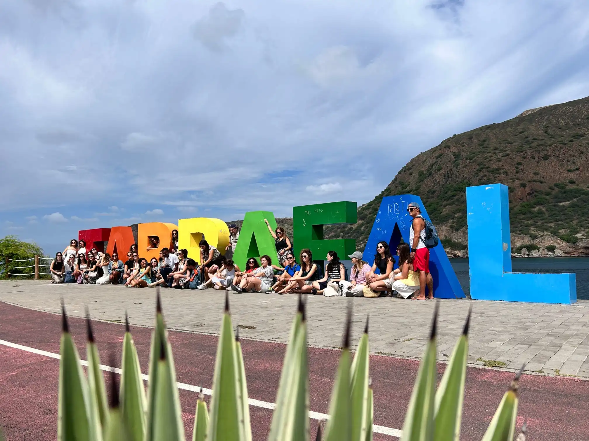 Volunteer group visiting the colourful Tarrafal sign on Santiago Island, showing the Cape Verde setting of Abroad Escape volunteer programs.