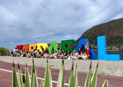 Volunteer group visiting the colourful Tarrafal sign on Santiago Island, showing the Cape Verde setting of Abroad Escape volunteer programs.